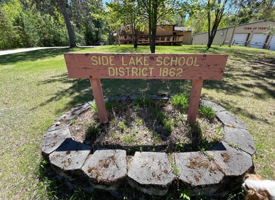 Image of Side Lake School District 1862 sign. Links to History