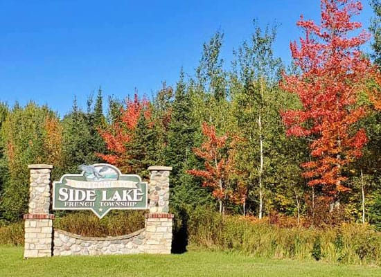 Image of the Side Lake French Township Sign and Fall trees. Links to Township News